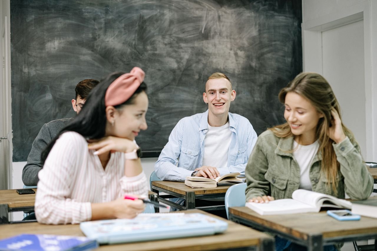 creative Group of teenagers actively participating in a classroom setting, focusing on their studies.