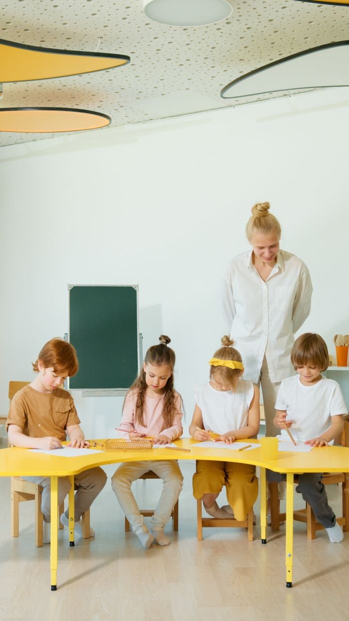 Services-02 A group of children with a teacher engaging in educational activities at a school.